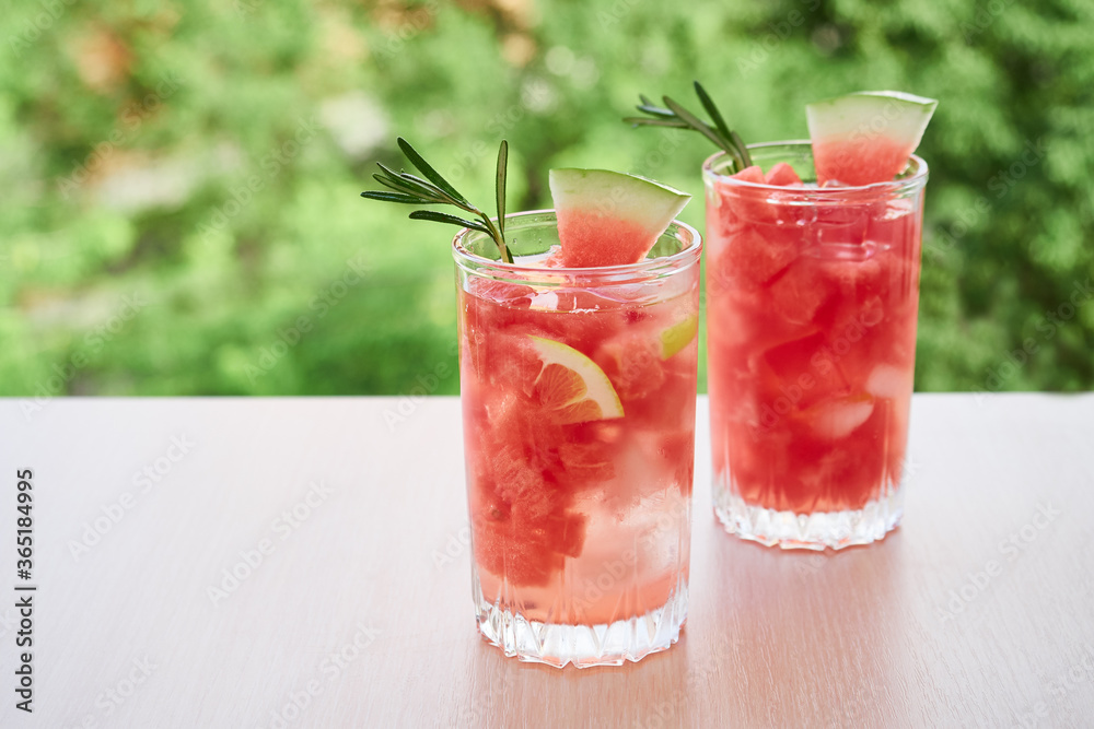 Summer refreshing drink with ice, slices of watermelon, lemon, rosemary, Summer refreshing drink with ice, slices of watermelon, lemon, rosemary,