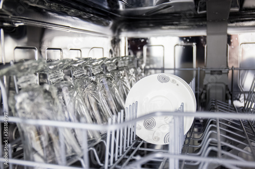 using dishwasher to save time in cleaning plates and glassware and routinely clean dirty dishes for hygiene with technology to remove stains