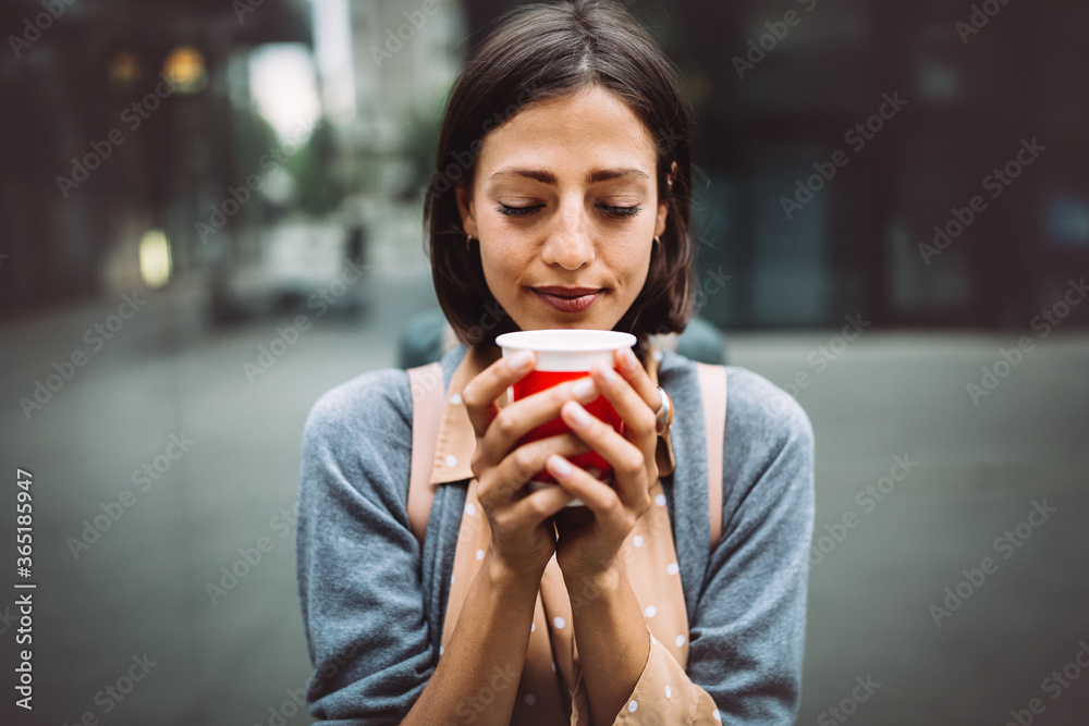 Happy young woman drinking take away coffee and walking with bags after shopping in city. Happy young woman drinking take away coffee and walking with bags after shopping in city.