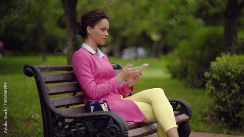 Fashionable beautiful young woman is talking on a smartphone