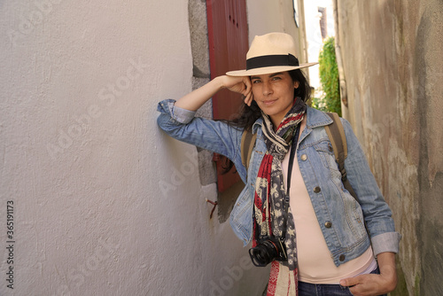 Tourist woman walking in narrow streets of small town