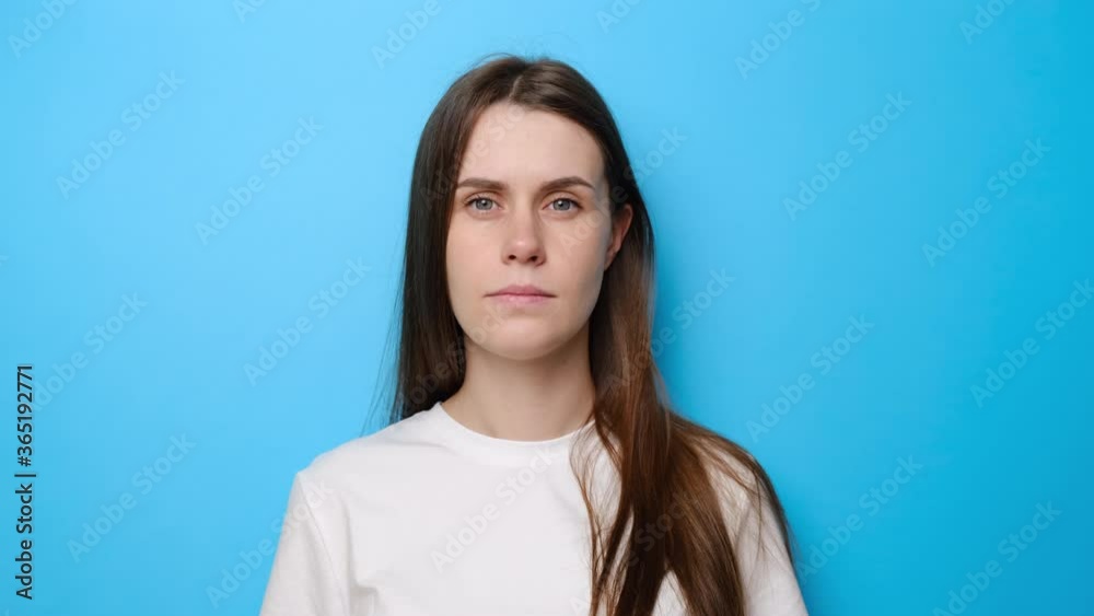 Portrait of young woman isolated on blue studio background shouting for joy and raising finger with great idea gesture, girl amazed surprised by suddenly found answer, genius plan, wears t-shirt. Portrait of young woman isolated on blue studio background shouting for joy and raising finger with great idea gesture, girl amazed surprised by suddenly found answer, genius plan, wears t-shirt.