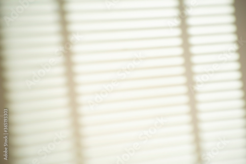 The shadowfrom the blinds of the window on a white wall in sunny weather with bright light. Shadow overlay effect for photo.