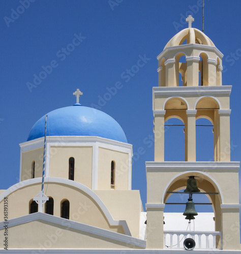 St George church (Ekklisia Agios Georgios) closeup of blue dome and bell tower in Oia, Santorini, Greece