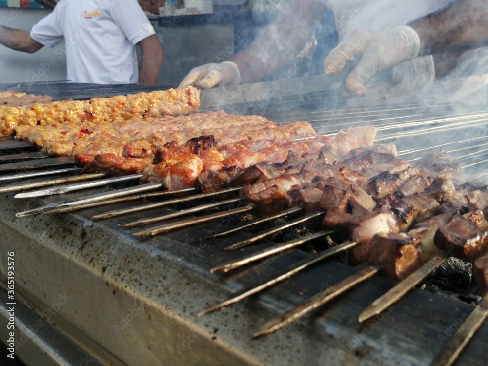 Shashlik preparing on a barbecue grill over charcoal. Shashlik or Shish kebab popular in Eastern Europe.