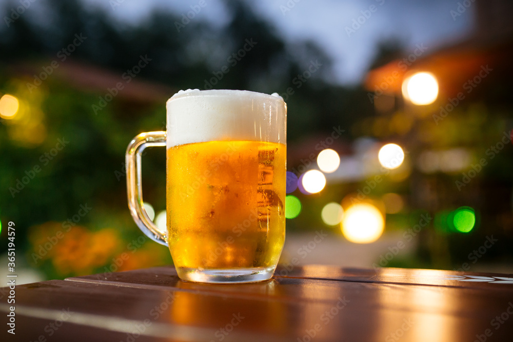 Beer foam outside with blurry lights background Beer foam outside with blurry lights background