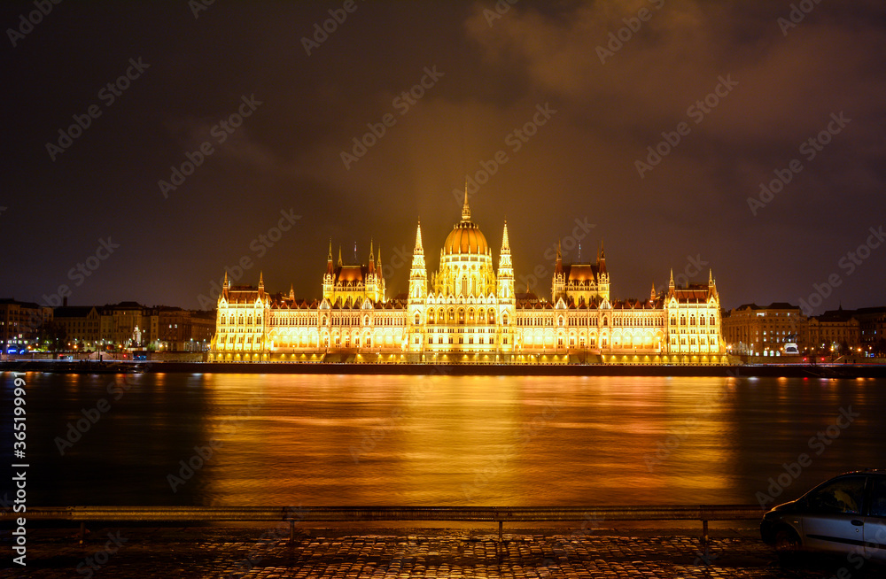 Night view of the Hungarian Parliament Building, a landmark of Hungary and a popular tourist destination in Budapest. The building is located on the on the eastern bank of the Danube