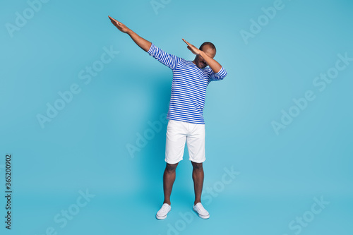 Full length photo off minded afro american guy dance dab hip hop disco event close cover face arms wear nautical vest footwear isolated over blue color background