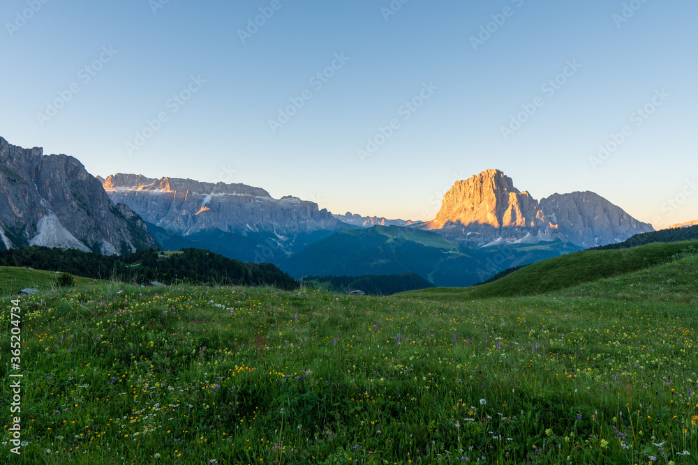 Dolomite mountain landscape at sunrise from Seceda peak, Italy.
