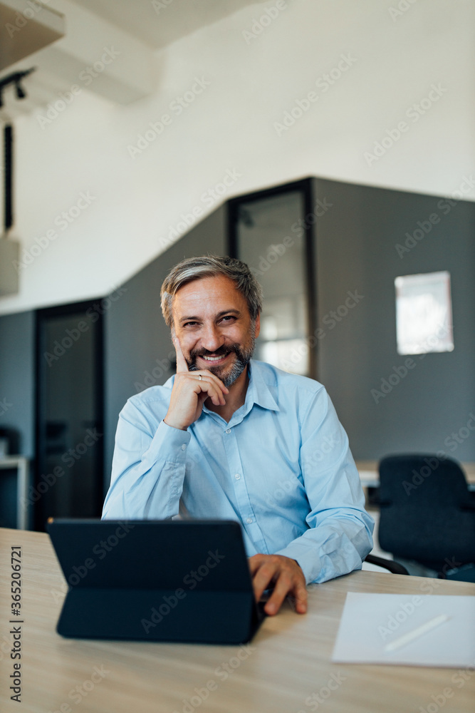 Portrait of a successful businessman in modern office. Portrait of a successful businessman in modern office.