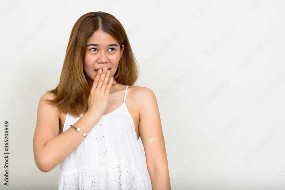 Portrait of young Asian woman against white background Portrait of young Asian woman against white background