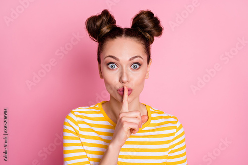 Close-up portrait of her she nice-looking attractive lovely pretty charming cute funky feminine cheery girl showing shh sign don't speak isolated over pink pastel color background photo
