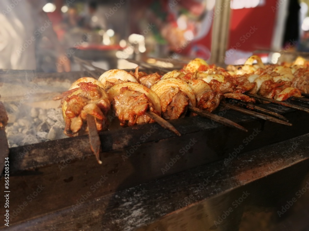 Shashlik preparing on a barbecue grill over charcoal. Shashlik or Shish kebab popular in Eastern Europe.