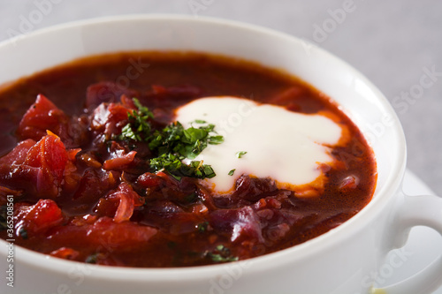 Traditional Ukrainian Russian borsch. Beetroot soup on gray background. Close up	
