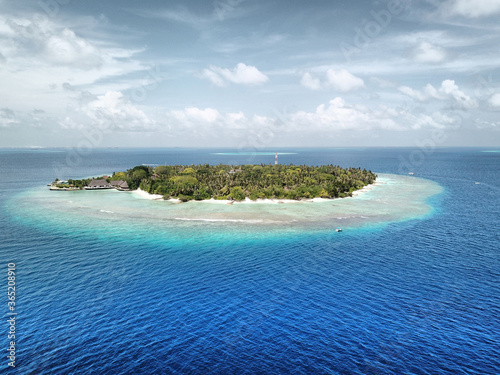 Maldives: Tropical Desert Island from Above, with White Sand Beach, Palm Trees, Turquoise Sea, Blue Sky and Dramatic Clouds (Bandos Maldives, North Male Atoll, Indian Ocean) DJI Mavic Pro Drone photo