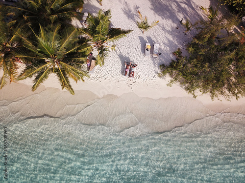 Family on Tropical Maldives Beach with Palm Trees and Turquoise Ocean Waves (Black Family on Vacation / Holiday) photo