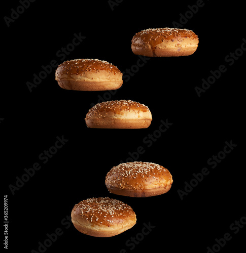 baked round sesame buns for sandwiches and hamburgers levitate