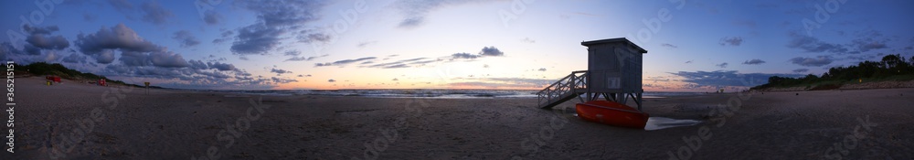 Sunset panorama with lifeguard tower on the beach. Baywatch lifeguard tower.