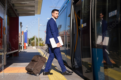 Young man in suit waiting at the train station