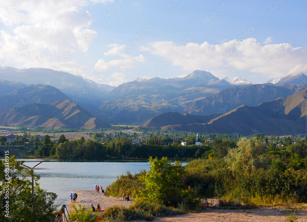 Calm scene at Lake Issyk Kul in Kyrgyzstan with mountains in the background