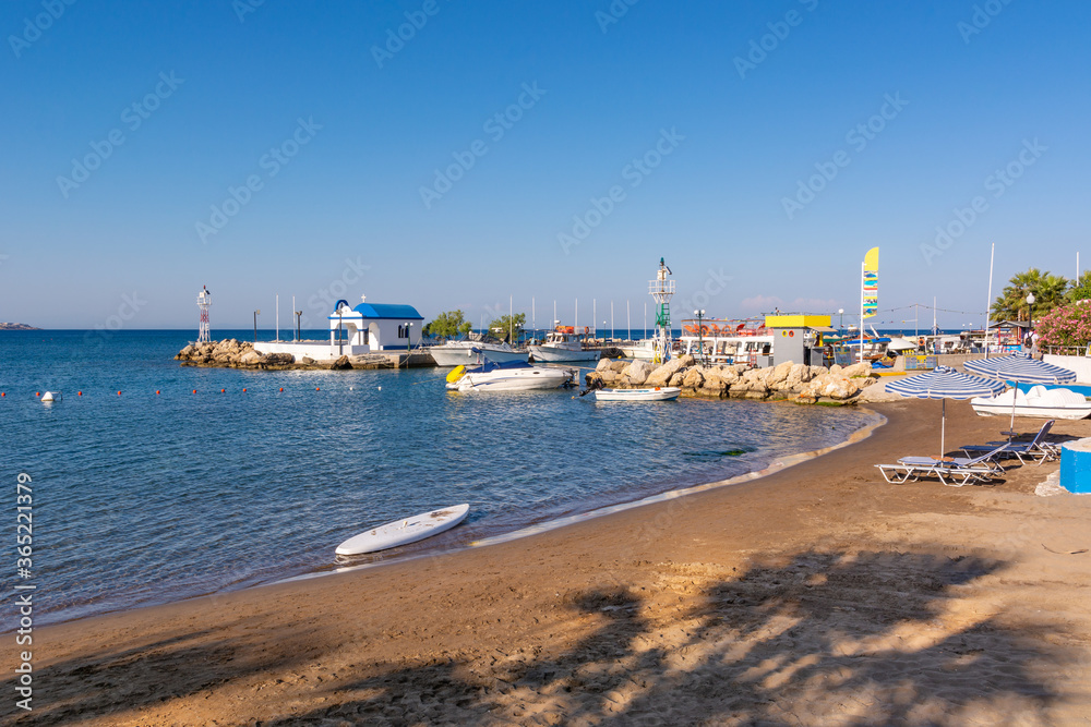 Sandy beach next to the Faliraki harbor on Rhodes island, Greece