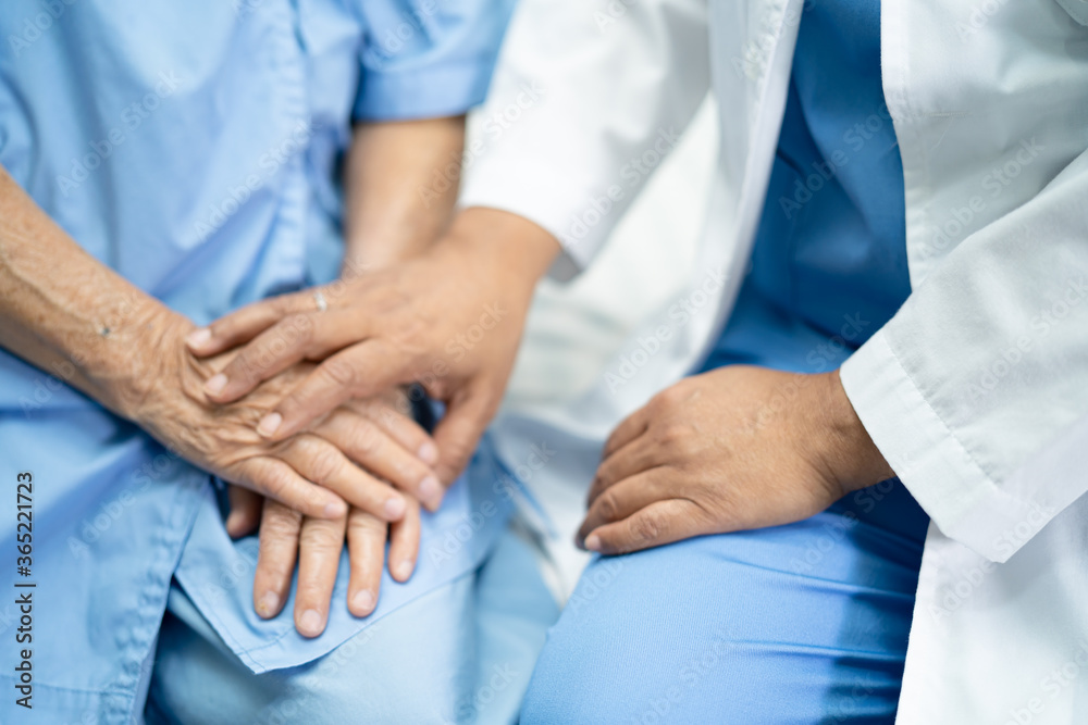 Doctor touching hands Asian senior or elderly old lady woman patient with love, care, helping, encourage and empathy at nursing hospital ward, healthy strong medical concept Doctor touching hands Asian senior or elderly old lady woman patient with love, care, helping, encourage and empathy at nursing hospital ward, healthy strong medical concept