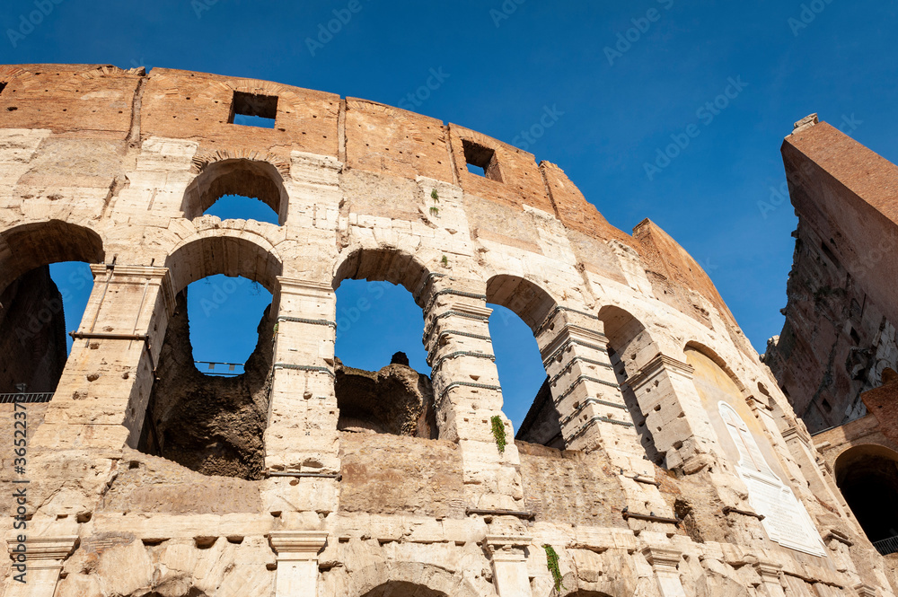 Architectural details of the facade of the Colosseum (Coliseum) or Flavian Amphitheatre, the largest Roman amphitheater located in city of Rome, Italy Architectural details of the facade of the Colosseum (Coliseum) or Flavian Amphitheatre, the largest Roman amphitheater located in city of Rome, Italy