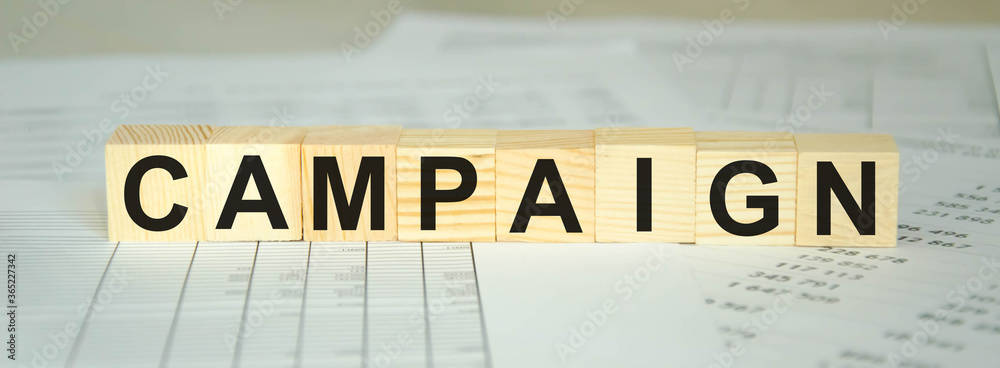 text campaign written on cubes and financial statements. financing text campaign written on cubes and financial statements. financing