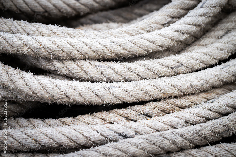 Mooring rope old frayed boat then piled on the floor. Ship or rock climbing tackle. Mooring rope old frayed boat then piled on the floor. Ship or rock climbing tackle.