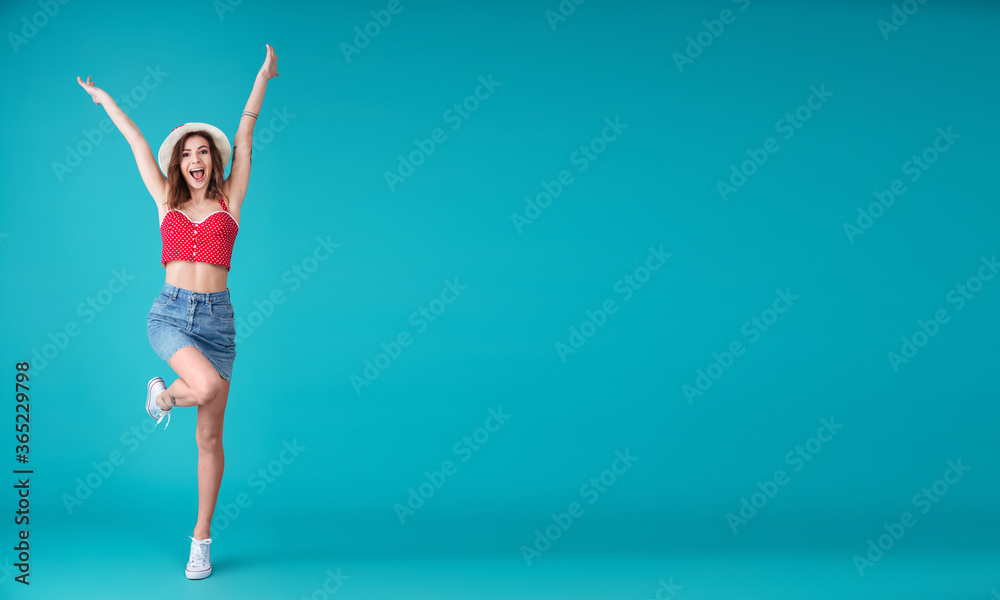 Happy young lady standing and posing isolated