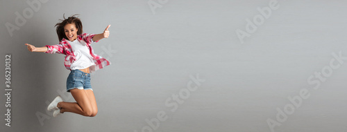 Full-length portrait of pretty jumping girl in casual wear, show © Drobot Dean