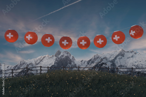 Obraz na plátně Hängende Lampion mit Schweizer Fahnen über Bergweide und vor Schweizer Alpen