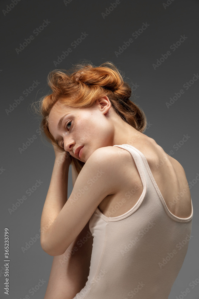 Dreams. Fashion portrait of beautiful redhead woman isolated on grey studio background. Concept of beauty, skin care, fashion and style. Artwork, modern and trendy portrait. Attractive model. Dreams. Fashion portrait of beautiful redhead woman isolated on grey studio background. Concept of beauty, skin care, fashion and style. Artwork, modern and trendy portrait. Attractive model.