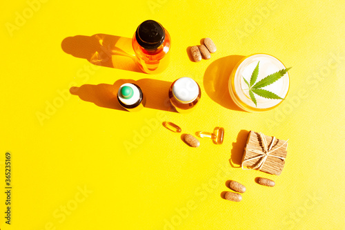 Natural cosmetics with hemp oil on a yellow background