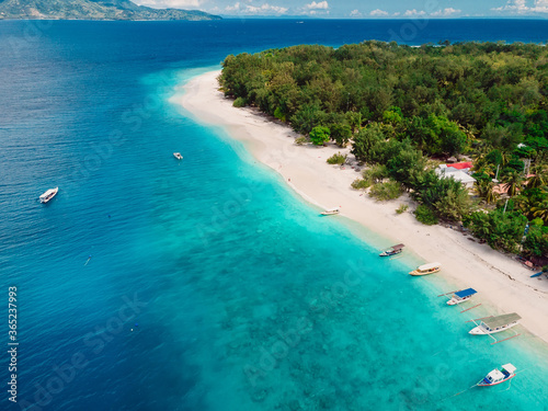 Tropical Gili island with beach and turquoise ocean.