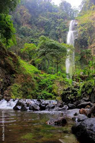 waterfall in the forest, curug cimahi bandung, indonesia photo