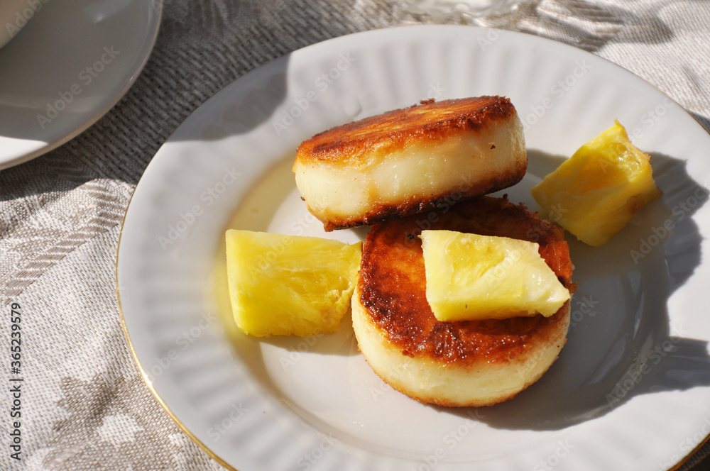 Tasty cheese pancakes with pineapple slices Tasty cheese pancakes with pineapple slices