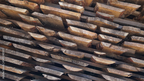 Stacked pine timber, sawn raw boards as background