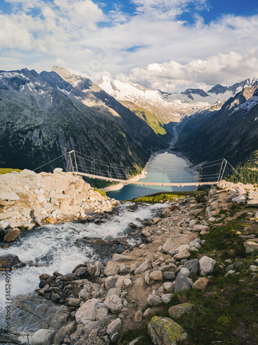 Hiking to the Olpererhutte or Olperer Hut in the Zillertal Alps is an experience that challenges all the senses. Famous instagram swing bridge. Landscape vacation trip, lifestyle holiday concept photo