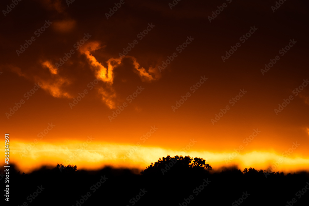 Dramatic orange evening sky with clouds at sunset