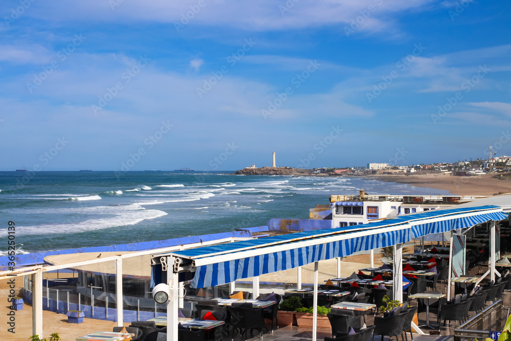 Empty restaurant on Cornish Boulevard with views of the Atlantic ocean and El Hank lighthouse, Casablanca, Morocco