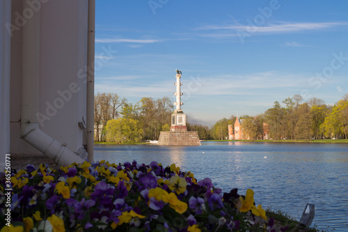 View from the Turkish bath Pavilion and flowers on the Chesma column of Catherine Park, standing in the lake. photo
