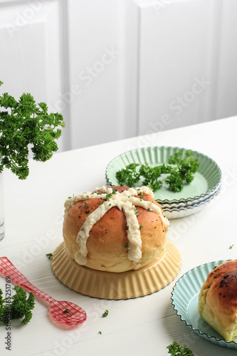 Korean Garlic Cream Cheese Bread (Yugjjog Maneulppang) is Popular Street Food in Korea. Made from Bread Bun, Cream Cheese, Garlic, Parsley, and Honey. White Concept Bakery photo