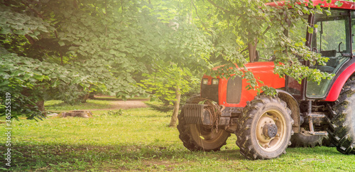 Large red tractor on the farm. Agriculture. Technology . 