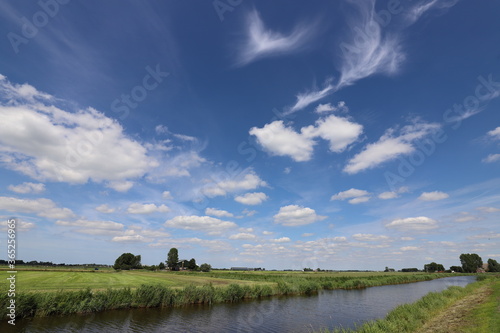 Real amazing beautiful blue sky above rural meadow landscape.
