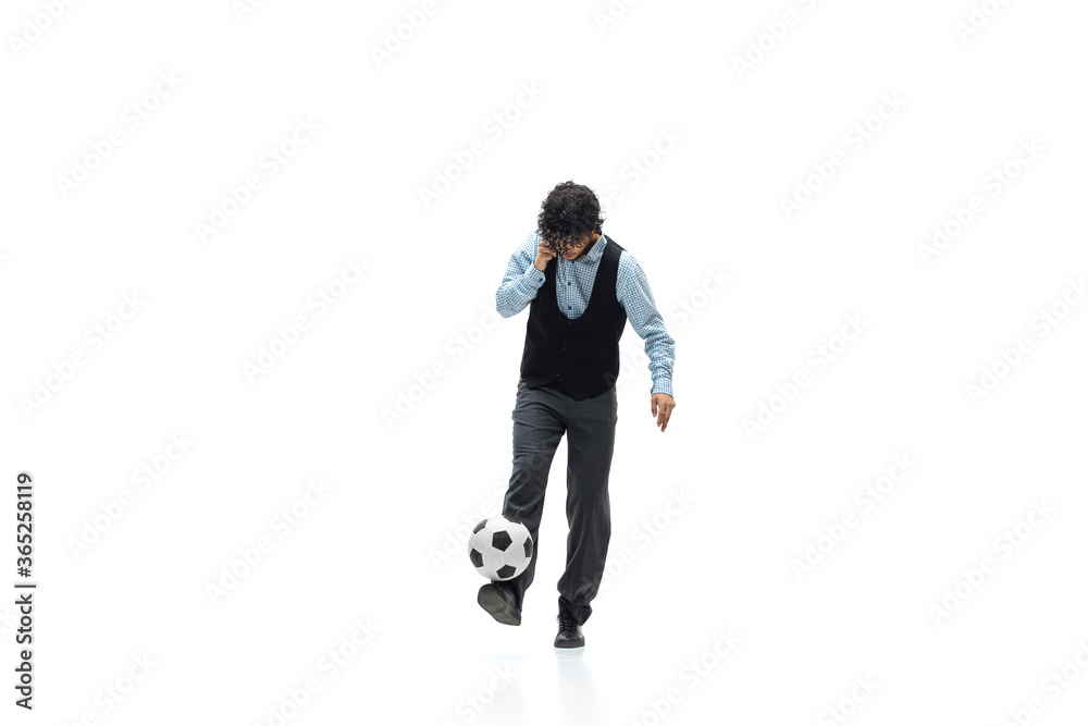 Man in office clothes playing football or soccer with ball on white background like professional player. Unusual look for businessman in motion, action kicking ball. Sport, healthy lifestyle Man in office clothes playing football or soccer with ball on white background like professional player. Unusual look for businessman in motion, action kicking ball. Sport, healthy lifestyle