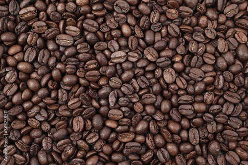 Close-up background of roasted coffee beans. © manbetta