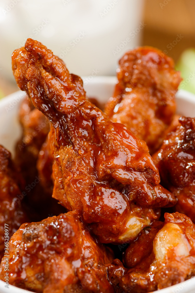 Macro on Buffalo drumsticks. Ruddy crust of succulent meat fried in hot sauce Macro on Buffalo drumsticks. Ruddy crust of succulent meat fried in hot sauce