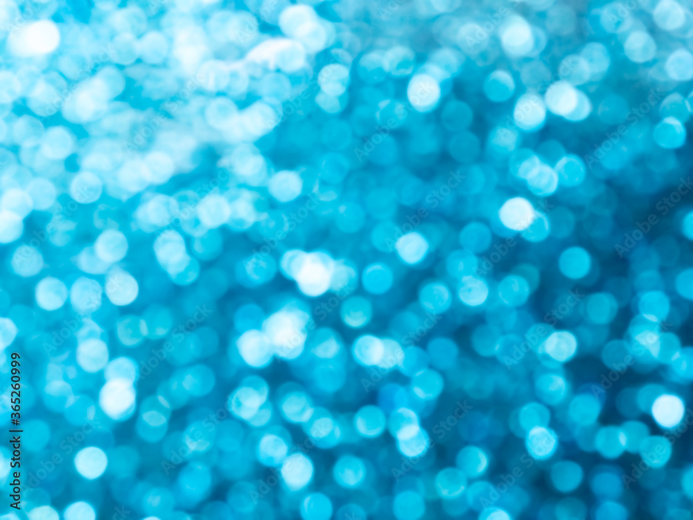 Abstract colorful blue and silver small bokeh Looks bright effect texture on black background. glitter vintage lights defocused elegant for Christmas or celebrate. Sparkling magical dust particles.