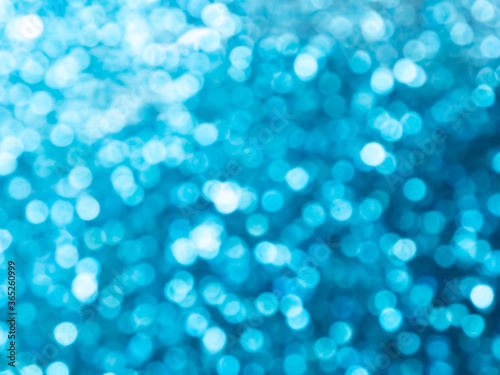 Abstract colorful blue and silver small bokeh Looks bright effect texture on black background. glitter vintage lights defocused elegant for Christmas or celebrate. Sparkling magical dust particles.
